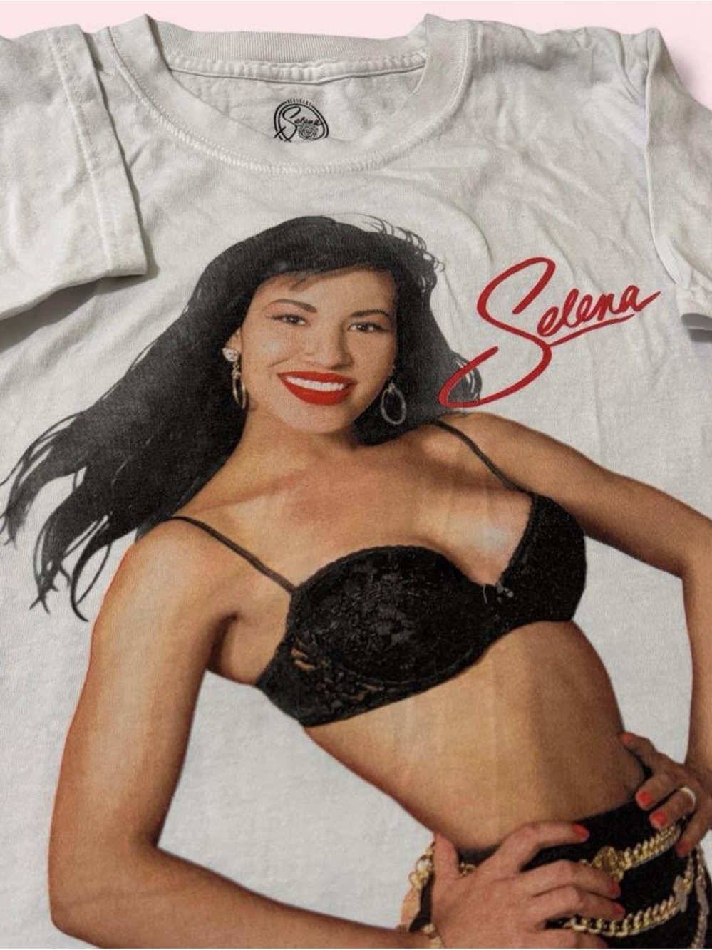 Official Merchandise Selena White Short-Sleeve Graphic Tee with Red Script Logo.